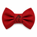A vibrant red bow tie with a detailed dog head logo in the center
