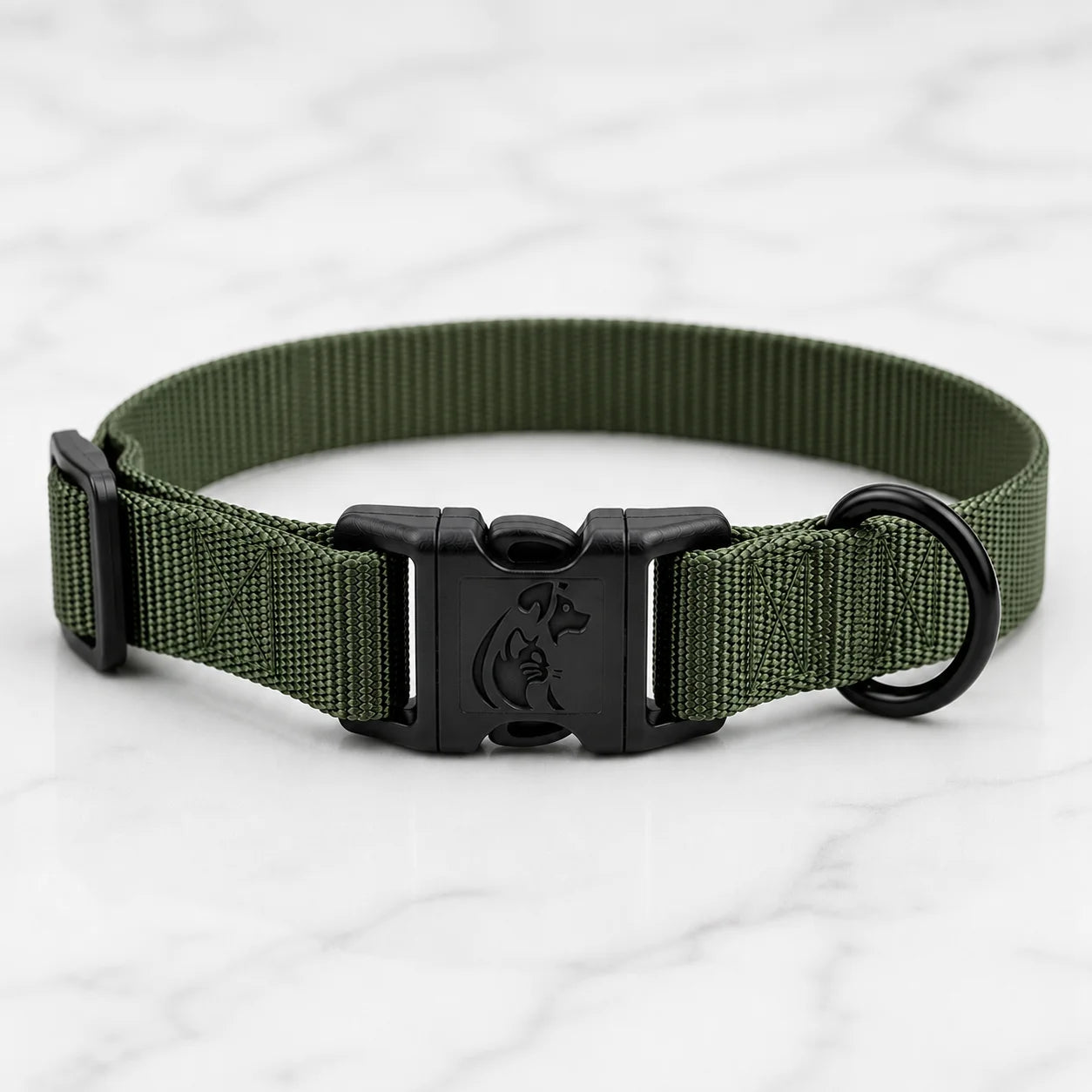 Olive green nylon dog collar with black plastic buckle and D-ring on white marble surface