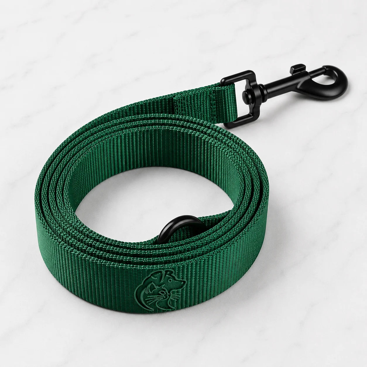 A green dog leash with a black clip and a dog logo on a white marble background