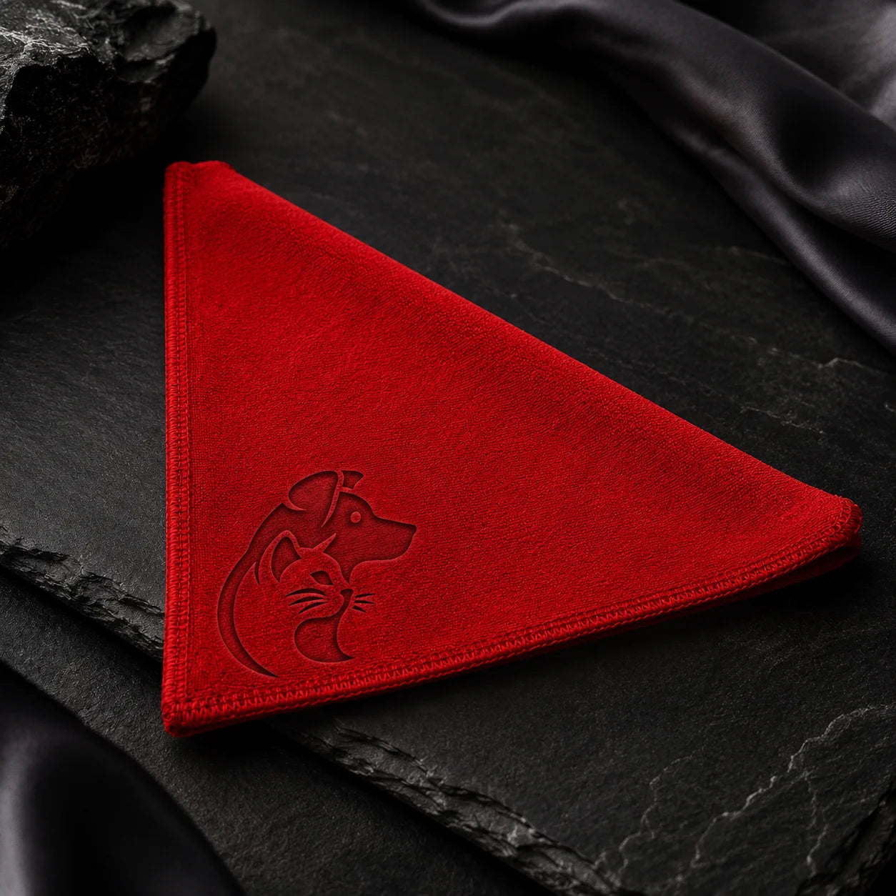 Red velvet dog bandana with embroidered dog on black slate background