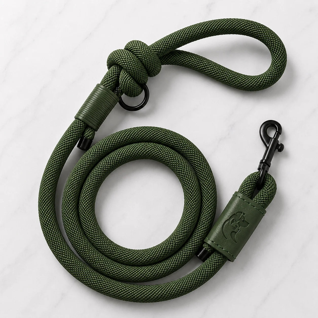 Olive green dog leash with black clips and leather accents on white marble background