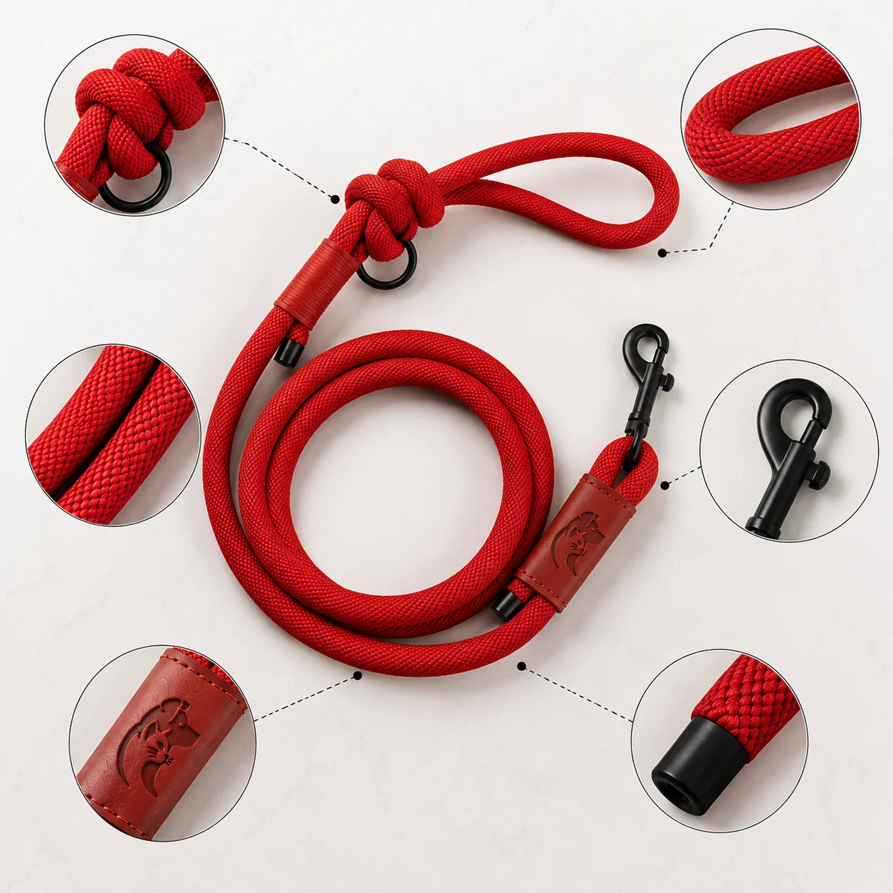 Red dog leash with black clips and leather handle details on white background